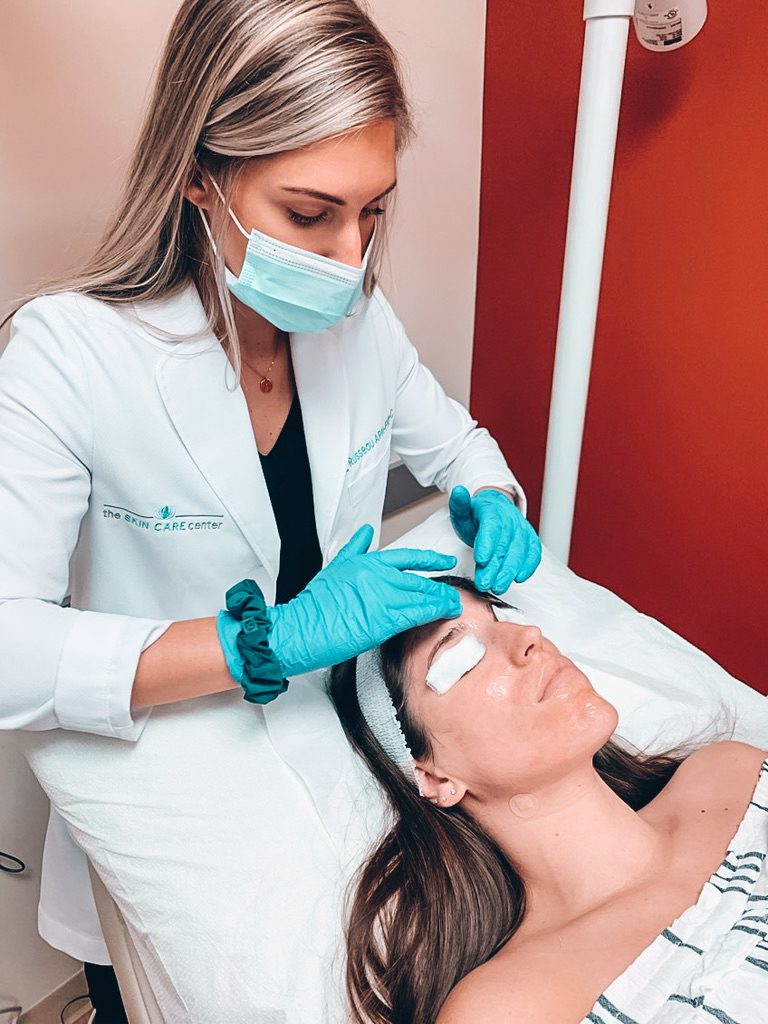 derm np elizabeth russeau treating patient on table